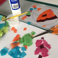 Materials needed to create stained glass design - tissue paper, stencil, glue and scissors