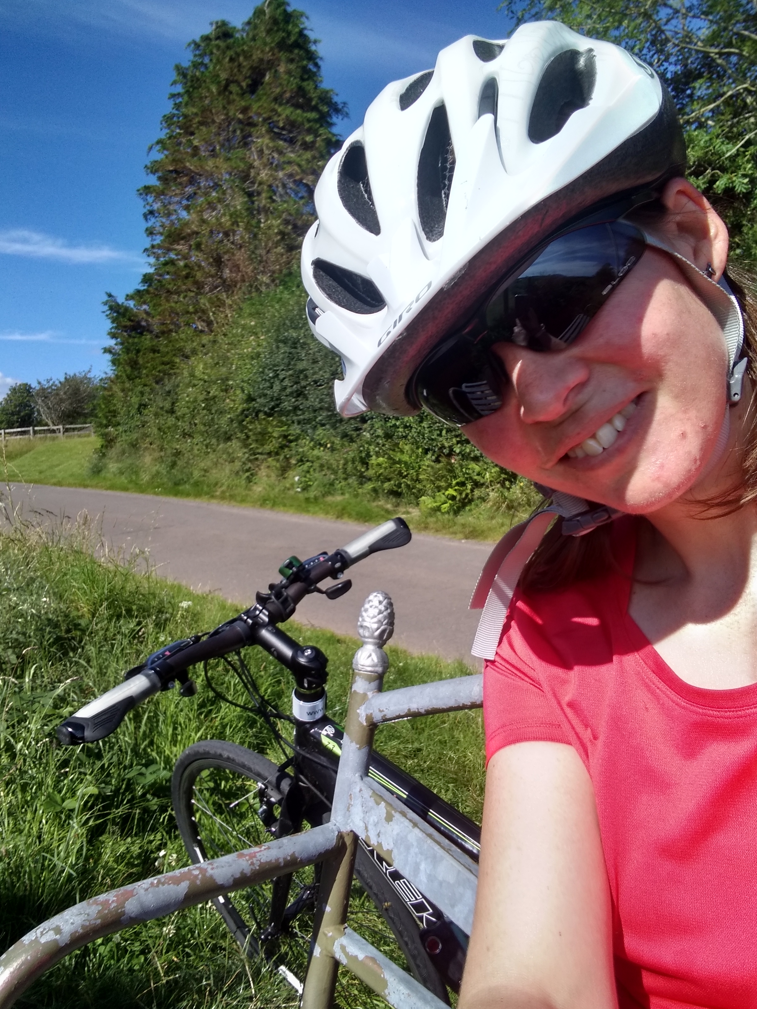 a woman in nature taking a selfie with a bike