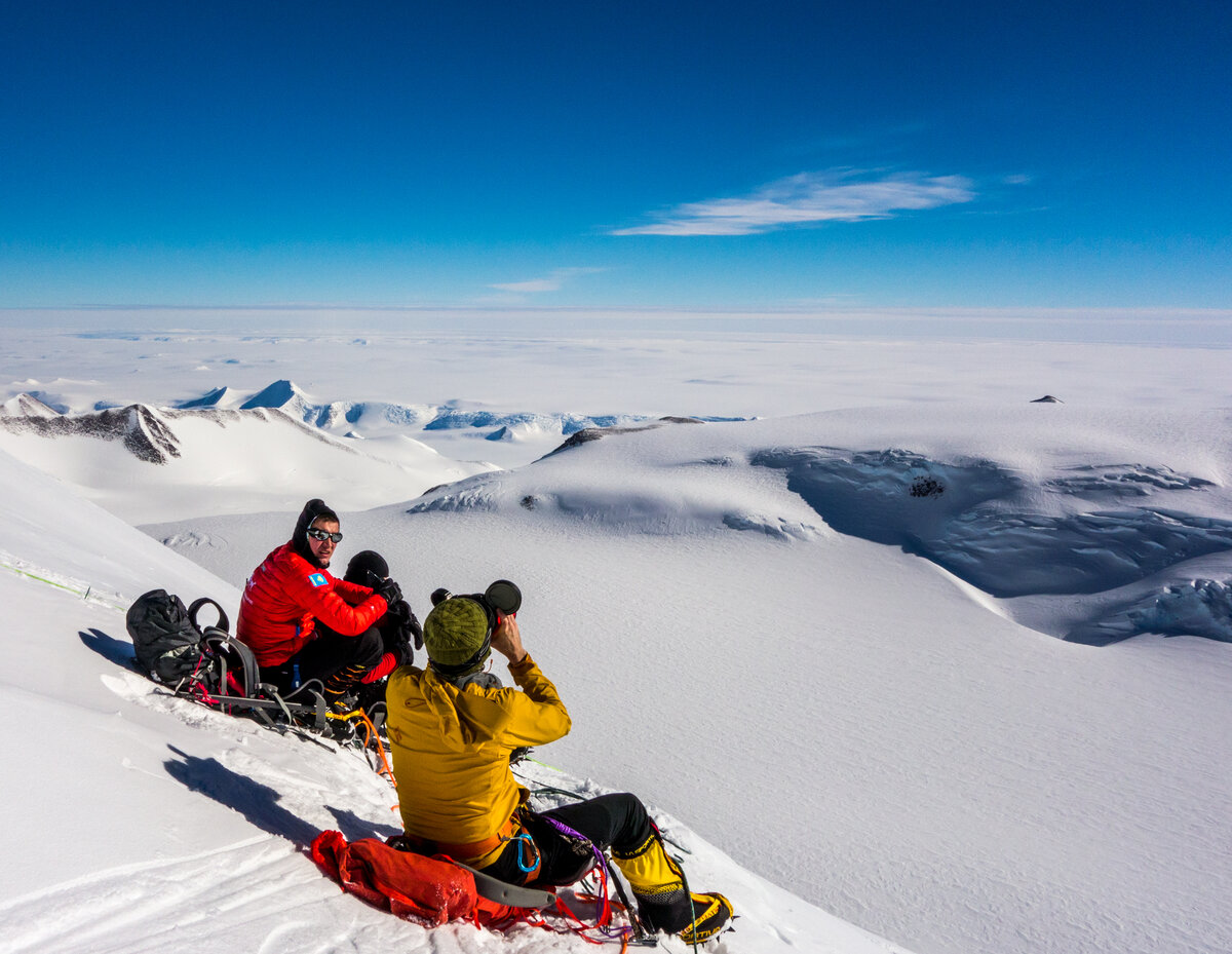 Two climbers take a break to enjoy sunshine and views