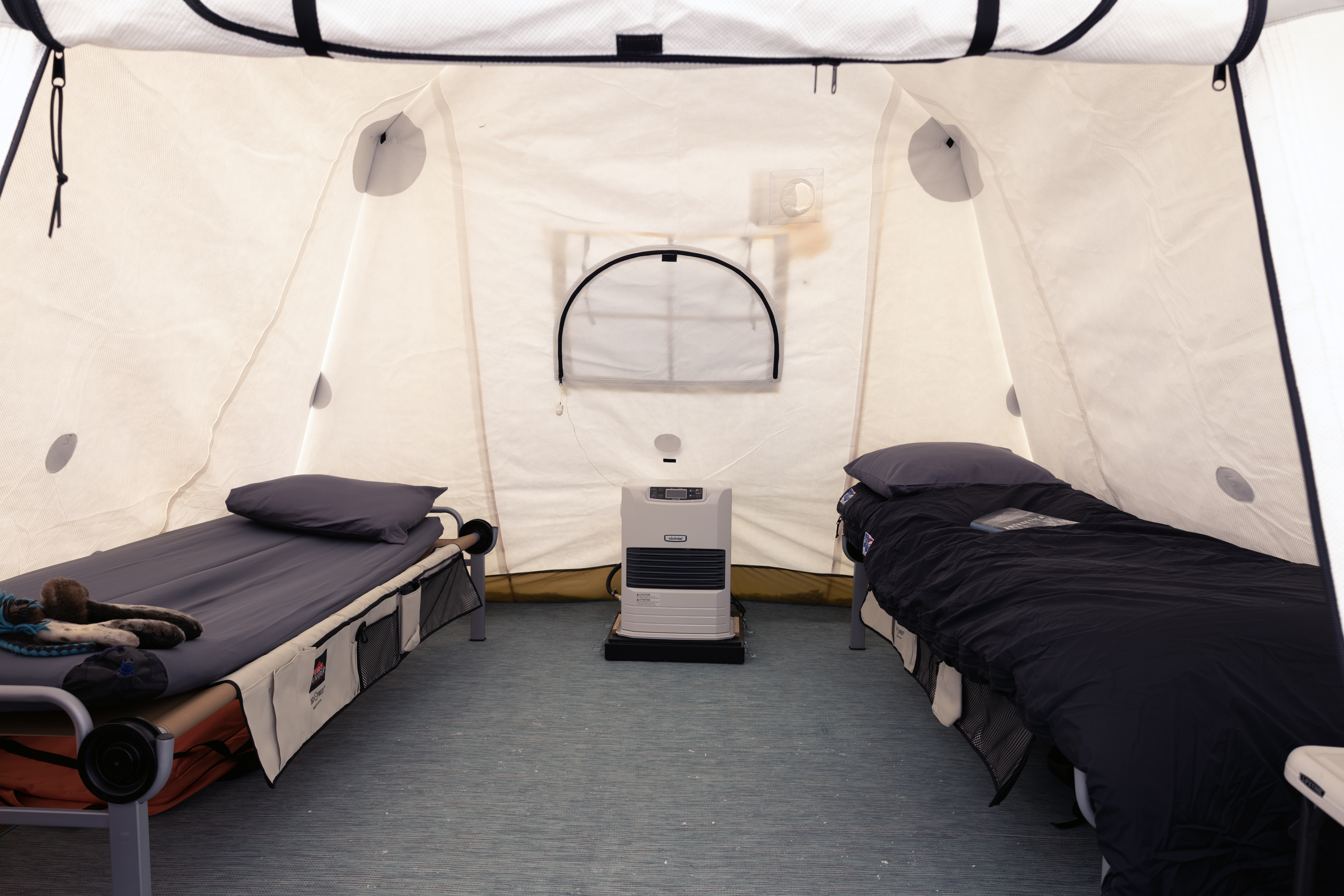 Each guest tent has two cots a table and heater